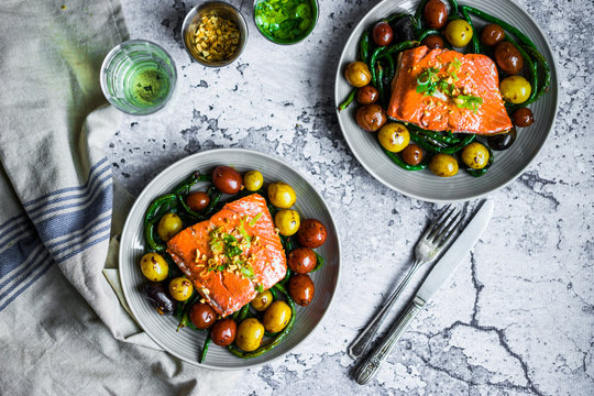 Grilled salmon with beans and potatoes on rustic background