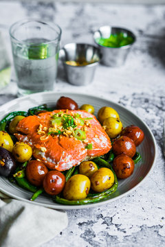 Grilled salmon with beans and potatoes on rustic background