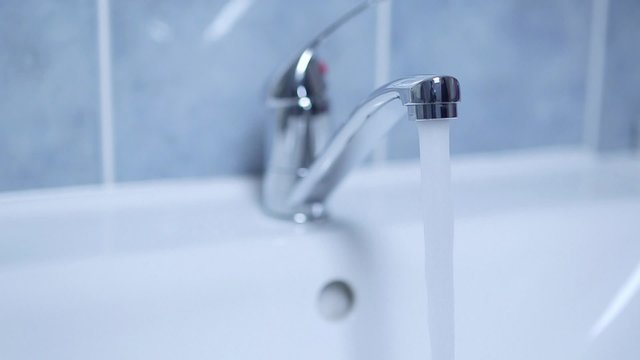 Hand opening faucet in domestic bathroom


