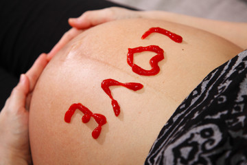 Word Love Written on Pregnant Belly