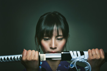 Beautiful japanese woman with samurai sword