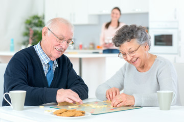 Fototapeta na wymiar Grandparents playing a board game