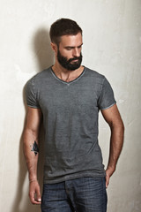 Bearded brutal guy wearing grey t-shirt