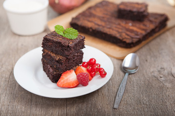 Healthy gluten free brownies made with sweet potato and coconut flour. Paleo style brownies on a wooden table, selective focus