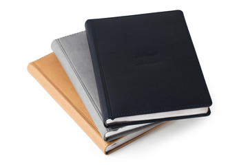 Pile of leather hardcover business diaries