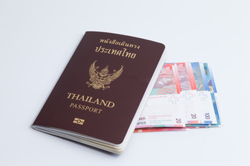 Fototapeta premium Thai passport with switzerland currency.
