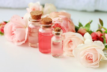 Obraz na płótnie Canvas Rose spa setting aromatic water in bottles natural freshness soft delicate flowers feminine beauty