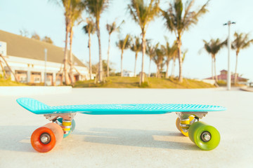 light blue longboard penny board with multicolored wheels ready