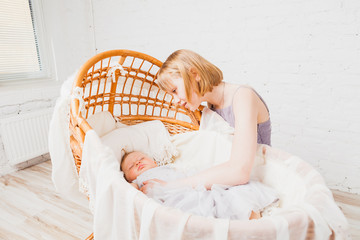Nice girl looking at little baby