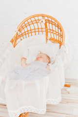 Osier cradle with sleeping baby