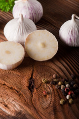 garlic, herbs and spices on wooden background