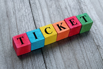 word ticket on colorful wooden cubes