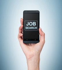 A hand holds a fancy smartphone. Words: ' Job search ' on the screen. A concept of recruitment. Light blue background.
