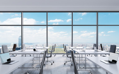 Workplaces in a modern panoramic office, New York city view from the windows. Open space. White tables and black leather chairs. A concept of financial consulting services. 3D rendering.