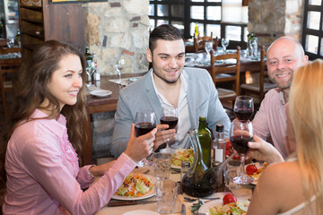 Young people enjoying food at tavern