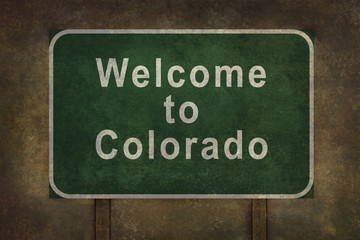 Welcome to Colorado roadside sign illustration, with ominous bac