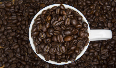 Cup of Coffee Beans Surrounded by Coffee Beans High Angle View