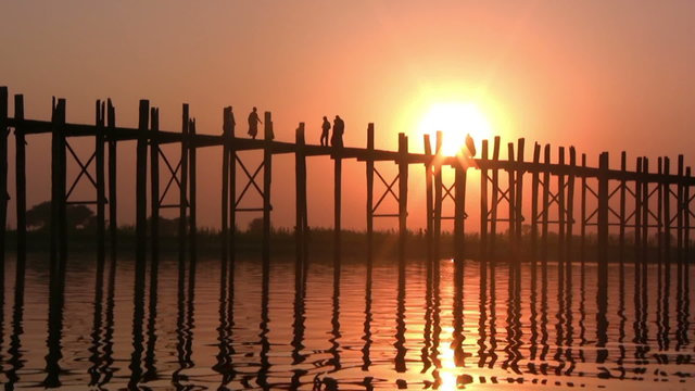 U Bein Bridge at sunset with people crossing Ayeyarwady River, Mandalay, Myanmar
