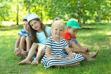 Happy active children on green grass in park