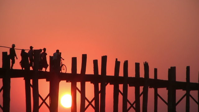 U Bein Bridge at sunset with people crossing Ayeyarwady River, Mandalay, Myanmar
