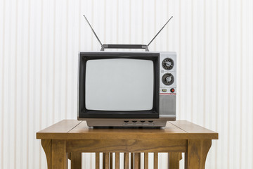 Old Portable Television with Antenna on Wood Table