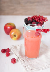 Fresh juice with berries in the bowl  on the white table