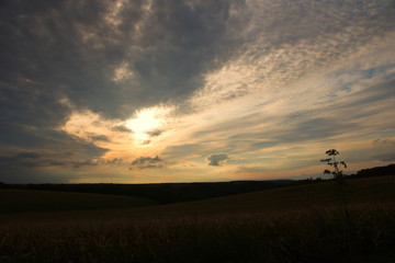 Fototapeta na wymiar Sunset with bursting clouds