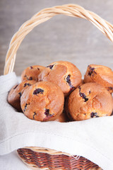 Bblueberry muffins in the wicker basket on the white wooden table