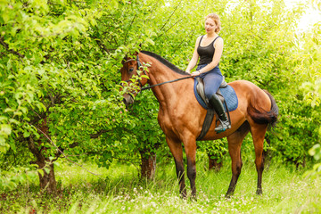 Woman jockey training riding horse. Sport activity