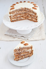 A piece of Hummingbird cake with pecans and cream cheese frosting