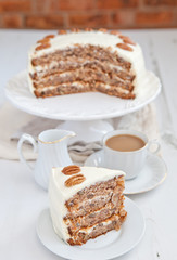 A piece of Hummingbird cake with pecans and cream cheese frosting