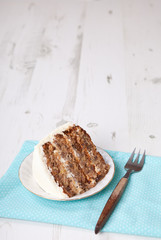 A piece of pecan cake with buttercream icing