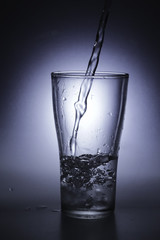 pouring cold water into a glass