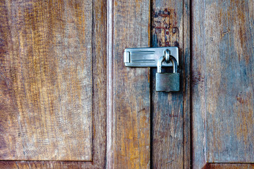 Old padlock on a wooden door