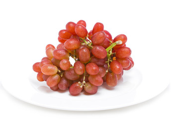 Fresh red grapes on white background.