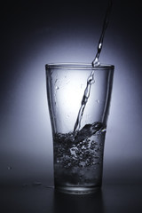 pouring cold water into a glass