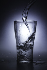 pouring cold water into a glass