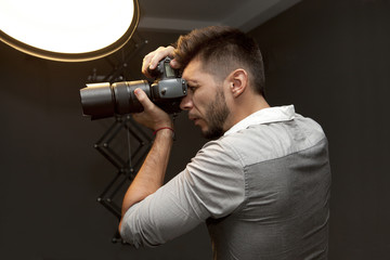 Young man with professional camera