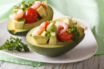 Tasty appetizer of avocado and shrimp salad close-up. horizontal
