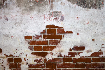Old red brick wall texture with plaster

