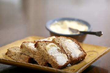 Freshly baked and sliced banana bread with butter