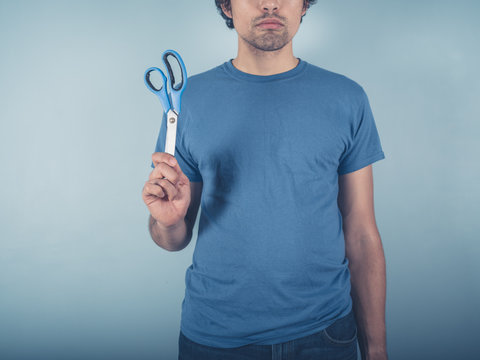 Young man with scissors