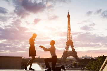 Fototapeta na wymiar Romantic marriage proposal at Eiffel Tower, Paris, France