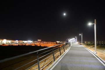 Fototapeta na wymiar Night pedestrian bridge over the highway in Orihuela Costa