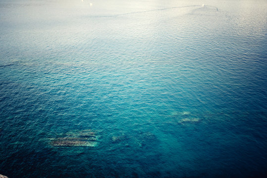 Fototapeta aerial view of clear ocean water, calm waves on a sunny day. Concept tranquill background