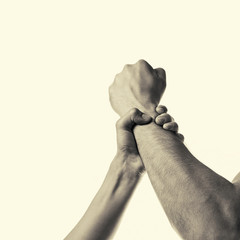 woman's hand gripping a man's fist stopping aggression