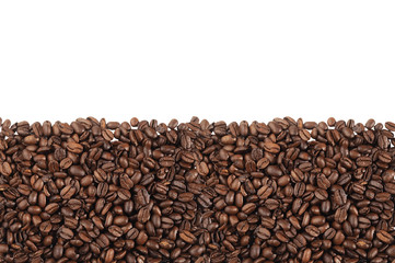 Close-up of roasted coffee beans over white background
