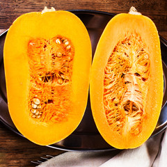Autumn pumpkin on wooden table with yellow leaves. Beautiful aut