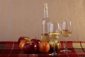 Bottle of wine two glasses and fruits