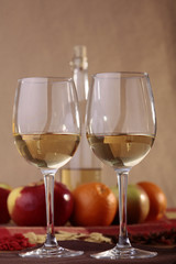 Pair glasses with bottle and fruits